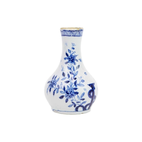 194 - A miniature 18th century Delft vase. Well painted in blue with a floral and pharmaceutical design in... 