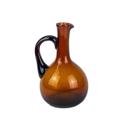 204 - A Victorian brown glass carafe and decanter. The carafe features an etched brass stopper and mount, ... 