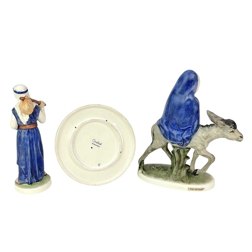 214 - Two Goebel figures and a Goebel candle holder. A 'Flight from Egypt' figure of Mary and Jesus, heigh... 