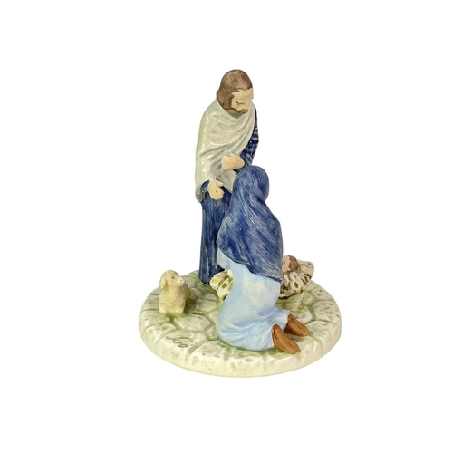 214 - Two Goebel figures and a Goebel candle holder. A 'Flight from Egypt' figure of Mary and Jesus, heigh... 