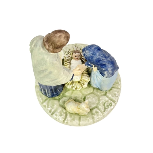 214 - Two Goebel figures and a Goebel candle holder. A 'Flight from Egypt' figure of Mary and Jesus, heigh... 