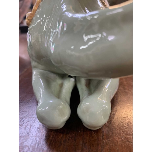 221 - A Royal Worcester porcelain camel modelled by James Hadley. Incised signature and impressed marks, h... 