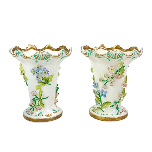 233 - A pair of English porcelain floral encrusted vases. Circa 1850, with wide scrolling rims, height 12c... 