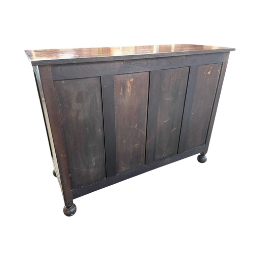 241 - A Heal's oak sideboard. Fitted with two drawers above a pair of cupboard doors, on ball feet, inset ... 