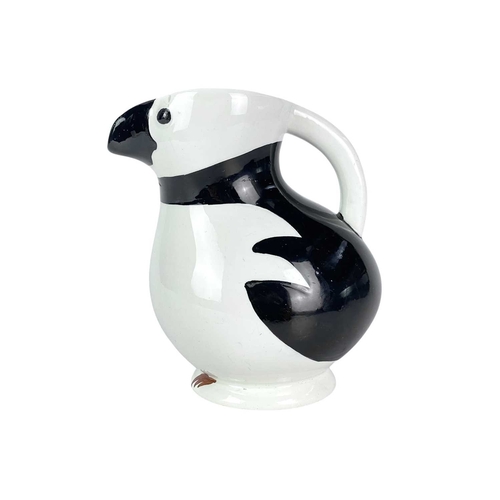 250 - A Norwegian Egersund puffin or razorbill jug. Mid-century, with black markings, the beak forms the s... 