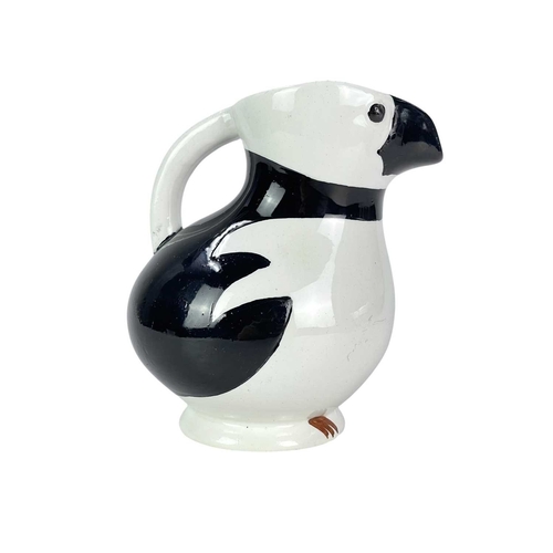 250 - A Norwegian Egersund puffin or razorbill jug. Mid-century, with black markings, the beak forms the s... 