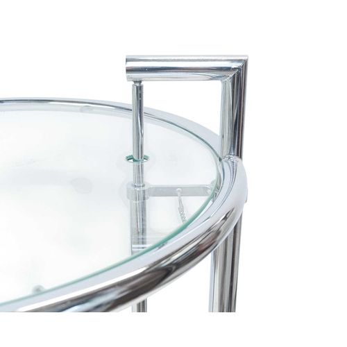 260 - A pair of chrome and glass E1027 tables, after Eileen Gray. Modern, with rise and fall glass tops, o... 