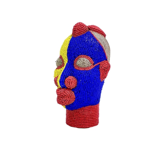 269 - An African beaded head ornament. Formed of terracotta with colourful glass bead overlay in red, blue... 