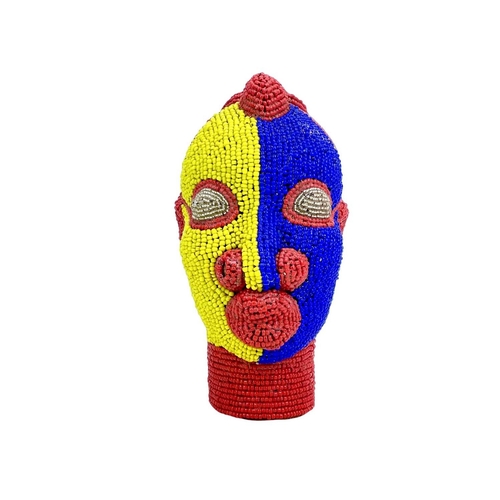 269 - An African beaded head ornament. Formed of terracotta with colourful glass bead overlay in red, blue... 