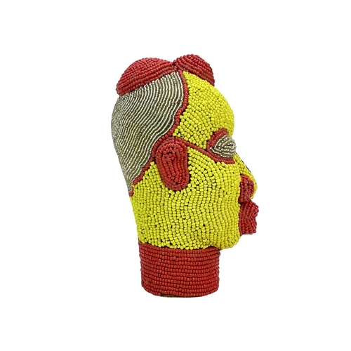 269 - An African beaded head ornament. Formed of terracotta with colourful glass bead overlay in red, blue... 