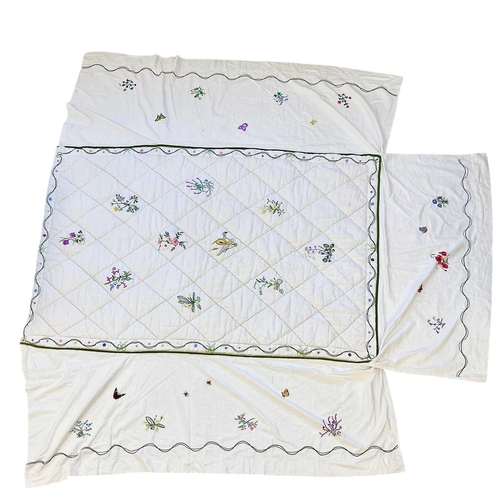 286 - A handsewn and embroidered single quilt with valance. White linen with hand embroidered flowers, wid... 