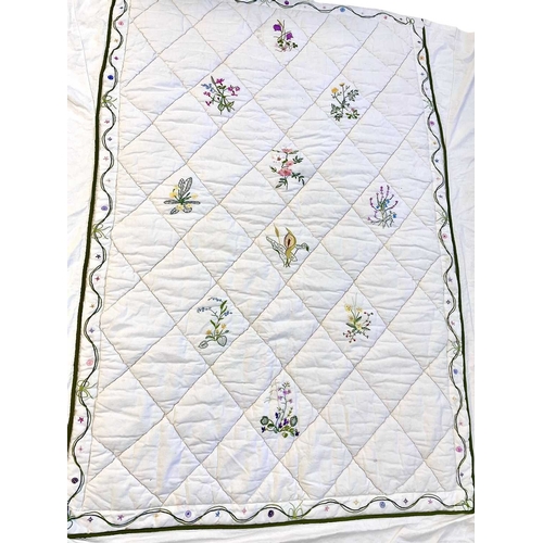 286 - A handsewn and embroidered single quilt with valance. White linen with hand embroidered flowers, wid... 