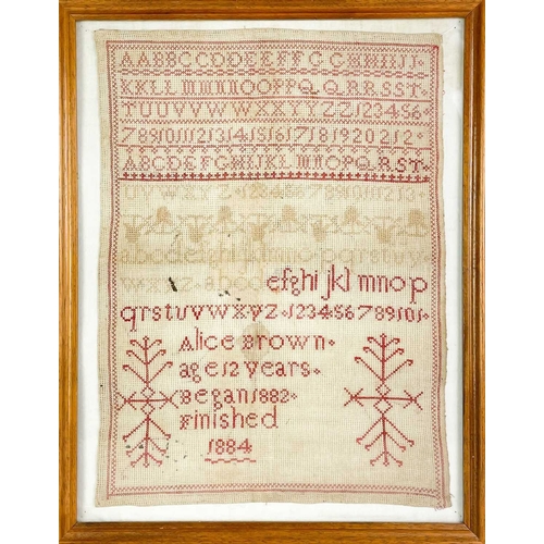 290 - A Victorian sampler. Worked in red wool thread with the alphabet and inscribed 'Alice Brown, age 12 ... 