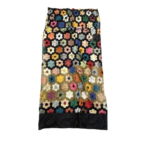 292 - A pair of patchwork curtains. Black and green silk interspersed with a hexagonal flower design, in v... 