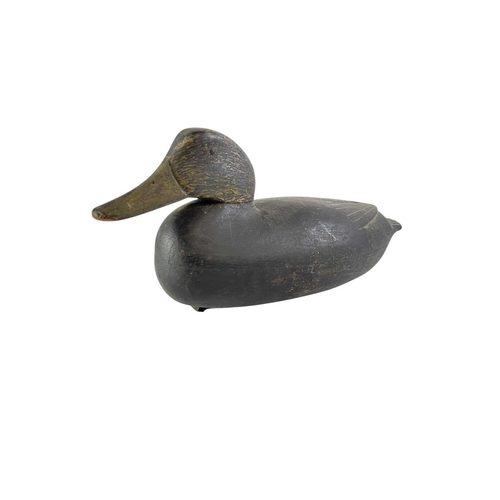 296 - An American black painted hollow duck decoy. Early 20th century, the lead weight with a copper plaqu... 