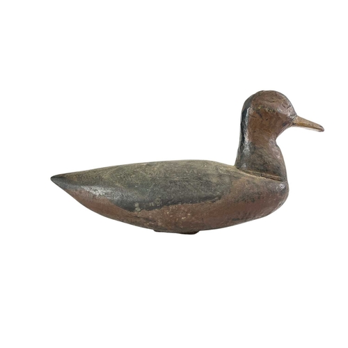 300 - An American painted carved wood duck decoy. Early 20th century, with original black and brown finish... 