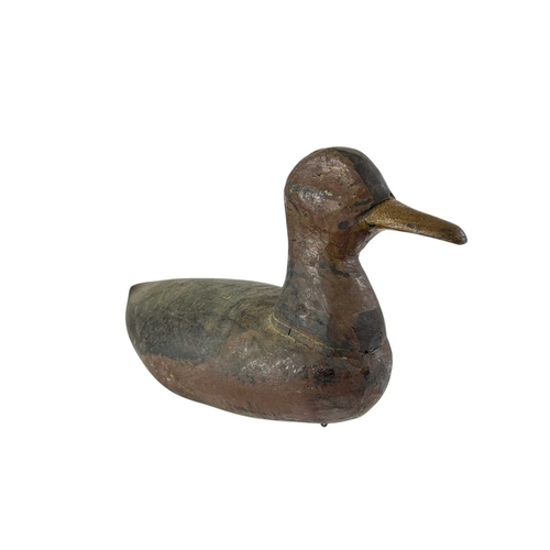 300 - An American painted carved wood duck decoy. Early 20th century, with original black and brown finish... 