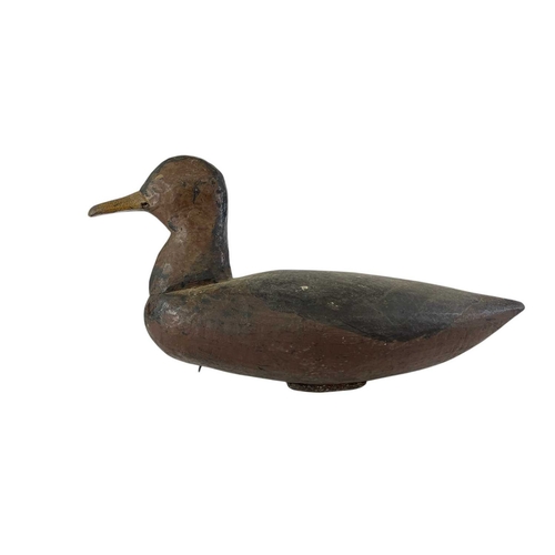 300 - An American painted carved wood duck decoy. Early 20th century, with original black and brown finish... 