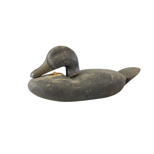 300 - An American painted carved wood duck decoy. Early 20th century, with original black and brown finish... 