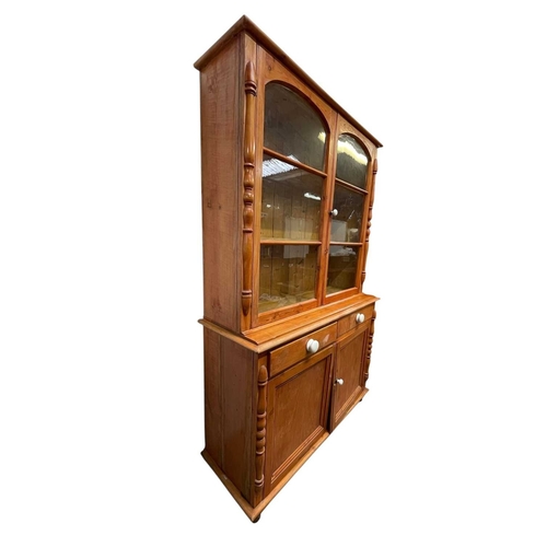 301 - A late Victorian West Country pine kitchen dresser. With two glazed doors above two drawers and two ... 