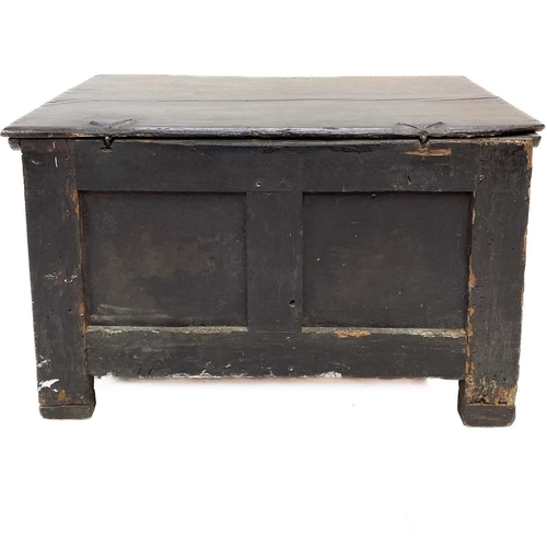 304 - An 18th century small oak coffer. Fitted a candle box, with a stop fluted frieze and two panel front... 