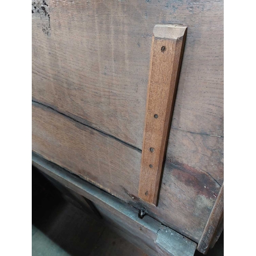 304 - An 18th century small oak coffer. Fitted a candle box, with a stop fluted frieze and two panel front... 