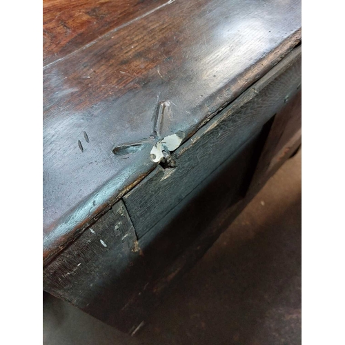 304 - An 18th century small oak coffer. Fitted a candle box, with a stop fluted frieze and two panel front... 