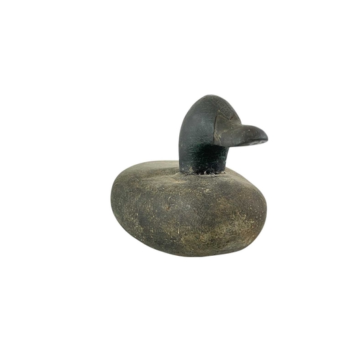 307 - An American carved pine duck decoy. Early 20th century, with a broad painted body, length 31cm, toge... 