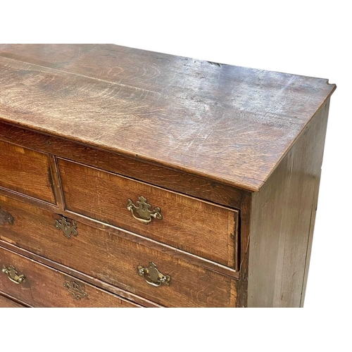 311 - A George III oak and crossbanded chest. Fitted two short and three long drawers, on bracket feet, he... 