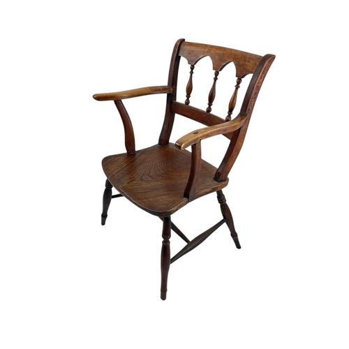 312 - A fruitwood and elm Windsor armchair. Circa 1860, with an arcaded spindle back, on turned legs, heig... 