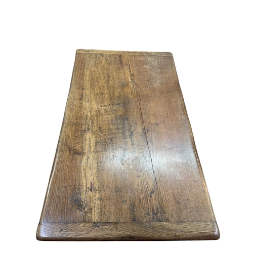 313 - An oak refectory dining table. Early 20th century, incorporating some earlier elements, the plank to... 