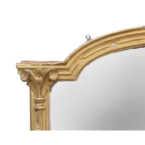 316 - A Victorian giltwood overmantel mirror. With an arched top, featuring two columns with stepped bases... 