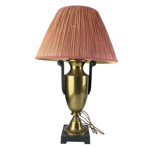 318 - A pair of brass urn table lamps. On raised black square bases, with black scrolling handles, height ... 