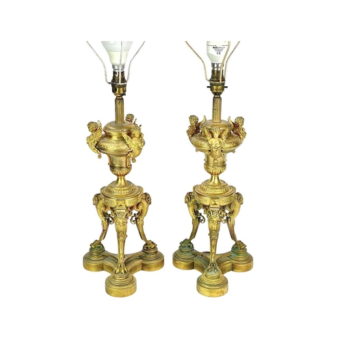 320 - A pair of French Napoleon III ormolu table lamps. Each with an urn support mounted with three winged... 