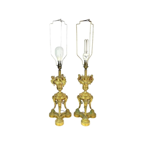 320 - A pair of French Napoleon III ormolu table lamps. Each with an urn support mounted with three winged... 