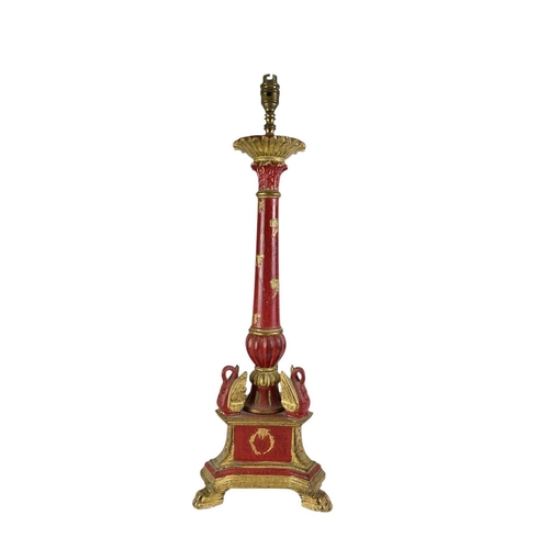 325 - A carved wooden gilt and red painted table lamp. Probably Italian, carved with wreaths and bows, (he... 