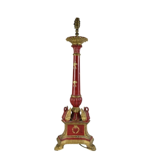 325 - A carved wooden gilt and red painted table lamp. Probably Italian, carved with wreaths and bows, (he... 