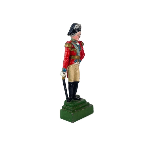 33 - A Victorian painted cast iron door stop of Nelson. On a stepped green base, height 40cm.