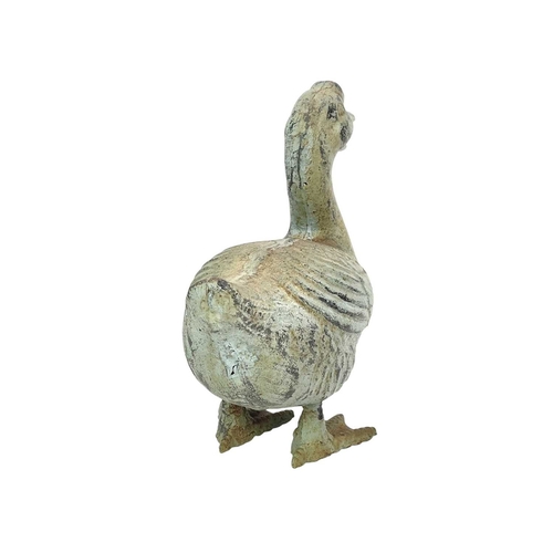 363 - A cast metal Chinese goose. Overpainted in a rustic green, height 25cm and width 23cm.