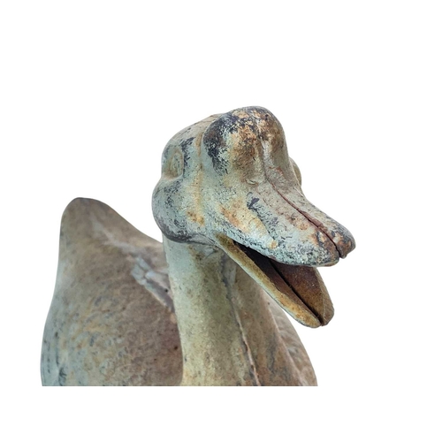 363 - A cast metal Chinese goose. Overpainted in a rustic green, height 25cm and width 23cm.