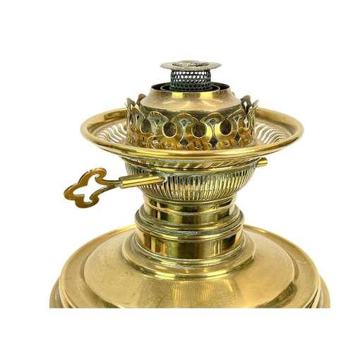 37 - A late Victorian brass oil lamp. With a clear etched glass shade, on a Corinthian column support, ov... 