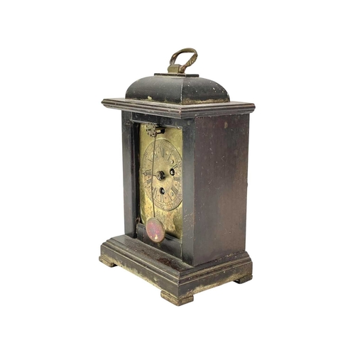 378 - A small continental pearwood cased timepiece. 19th century, With a brass face and forward facing vis... 