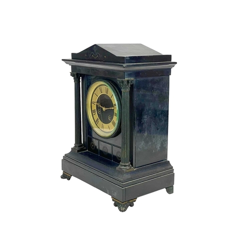 383 - A Victorian Aesthetic Movement black slate mantle clock. With twin column supports and cast metal fe... 