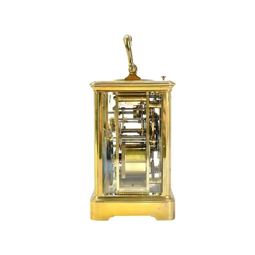 388 - A French repeating brass carriage alarm clock. Early 20th century, the white dial with alarm indicat... 