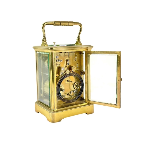 388 - A French repeating brass carriage alarm clock. Early 20th century, the white dial with alarm indicat... 