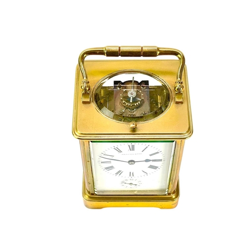 388 - A French repeating brass carriage alarm clock. Early 20th century, the white dial with alarm indicat... 