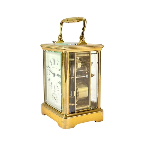 388 - A French repeating brass carriage alarm clock. Early 20th century, the white dial with alarm indicat... 