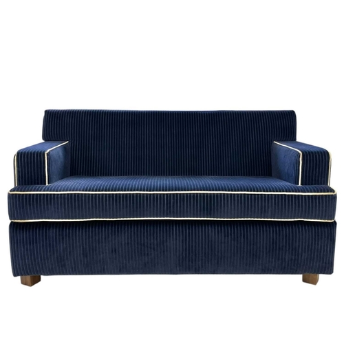 398 - ± Superyacht furnishings, a contemporary two-seater blue sofa. Upholstered in a chunky retro navy bl... 