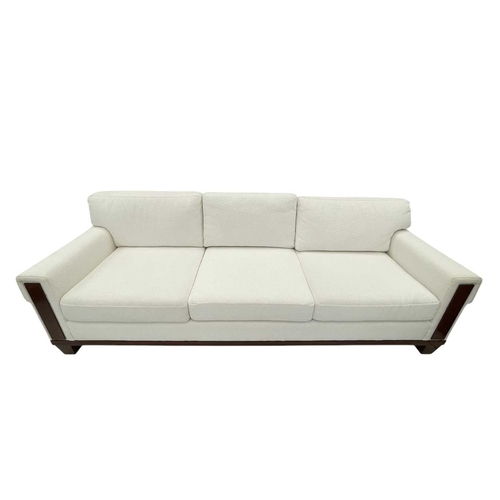 406 - ± Superyacht furnishings, a contemporary four/five seater sofa with white boucle fabric. On a highly... 