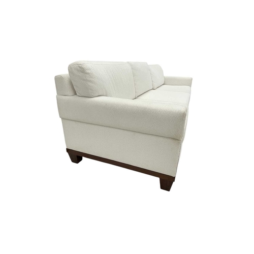 406 - ± Superyacht furnishings, a contemporary four/five seater sofa with white boucle fabric. On a highly... 